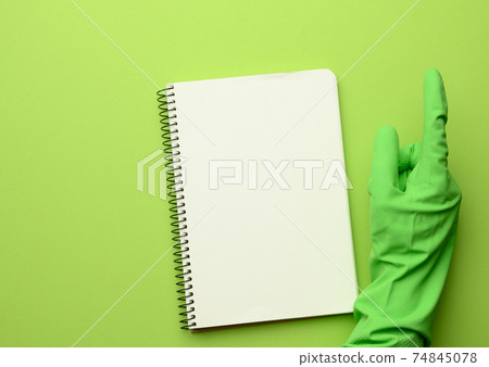 open paper notebook with blank white sheets, green background 74845078