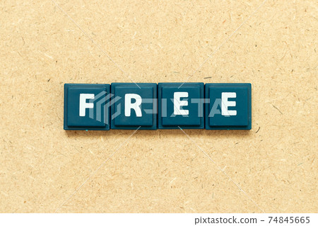Tile alphabet letter in word free on wood background Tile alphabet letter in word free on wood background 74845665