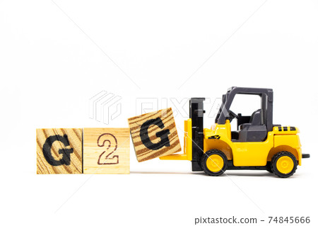 Toy forklift hold letter block G to complete word G2G (abbreviation of Government to government) on wood background Toy forklift hold letter block G to complete word G2G (abbreviation of Government to government) on wood background 74845666