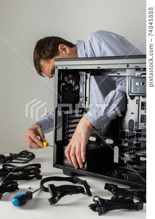 Male master assembles a new system unit 74845888