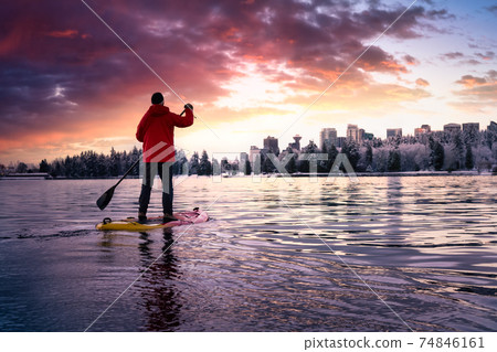 Adventurous male is paddle boarding near Stanley Park 74846161