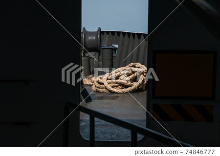 Rope on a sea boat for mooring a vessel is adhered to a pier. Rope on a sea boat for mooring a vessel is adhered to a pier. 74846777