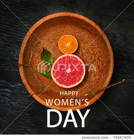 Grapefruit and orange in shape of number 8 isolated over dark background. 74847909