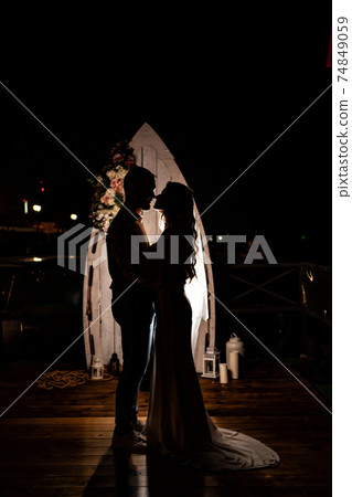 silhouette of the newlyweds in the dark. shooting at night. 74849059
