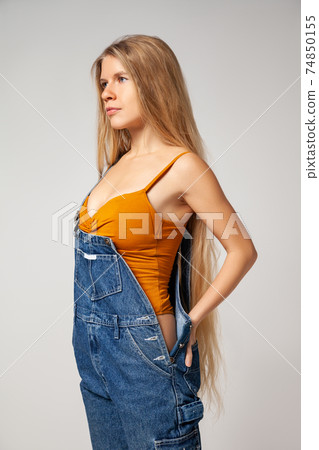 Positive hipster woman in trendy outfit against white background Positive hipster woman in trendy outfit against white background 74850155