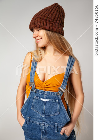 Positive hipster woman in trendy outfit against white background Positive hipster woman in trendy outfit against white background 74850156