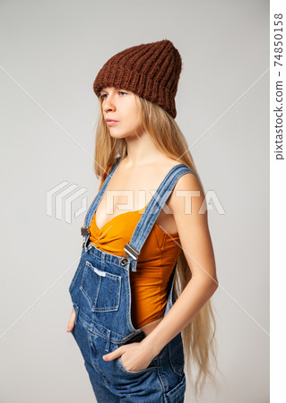 Positive hipster woman in trendy outfit against white background 74850158