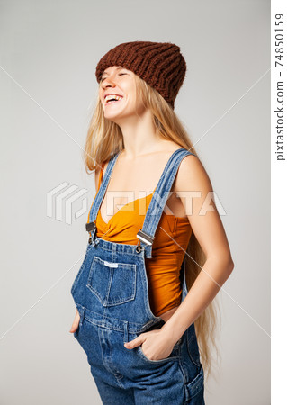 Positive hipster woman in trendy outfit against white background 74850159