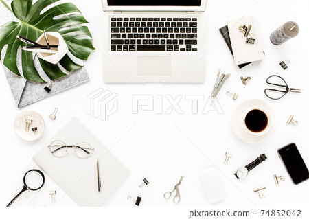 Home office workspace mockup with laptop, tropical leaves Monstera, clipboard, notebook and accessories on white background. Flat lay, top view 74852042