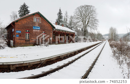 Historic single-track train station covered with fresh snow 74852253