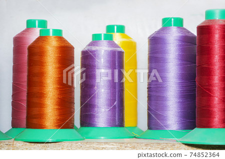 Colorful reels with threads, backgrounds, images related to the tailor. Colorful reels with threads, backgrounds, images related to the tailor. 74852364