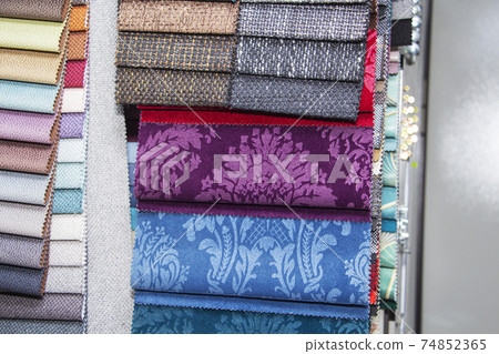 A set of fabric samples for furniture finishing. Multicolored upholstery stripes. A set of fabric samples for furniture finishing. Multicolored upholstery stripes. 74852365