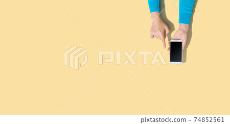 Person using a white smartphone Person using a white smartphone 74852561