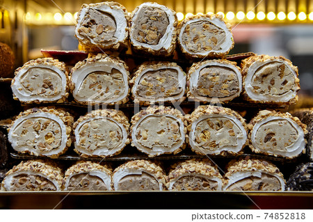 An oriental dessert, or Turkish delight in form of rolls, displa An oriental dessert, or Turkish delight in form of rolls, displa 74852818