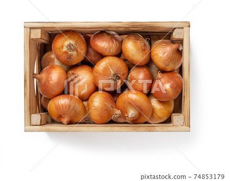 Wooden crate full of raw yellow onions isolated on white background. Wooden crate full of raw yellow onions isolated on white background. 74853179