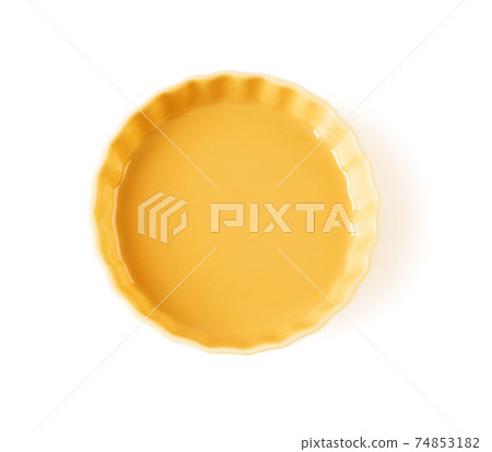 Top view of round yellow ceramic plate with wavy edge isolated on a white background. Top view of round yellow ceramic plate with wavy edge isolated on a white background. 74853182
