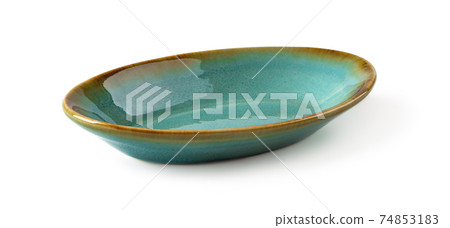 Side view of oblong turquoise ceramic plate isolated on a white background. Side view of oblong turquoise ceramic plate isolated on a white background. 74853183