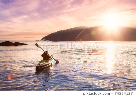 Adventurous Girl kayaking in the Pacific Ocean. 74854127