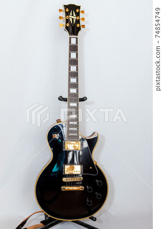 Black Les Paul standing on a stand Black Les Paul standing on a stand 74854749