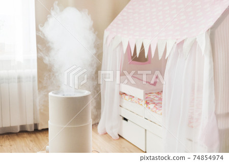 Modern air humidifier in children's room, aroma oil diffuser at home. Improving the comfort of living in a house, Improving the well-being. Baby care 74854974