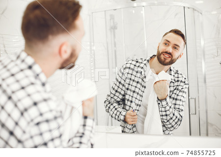 Portrait view of a young man brushing his teeth 74855725
