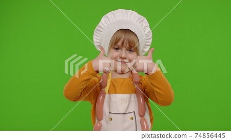 Child girl kid dressed as cook chef showing thumbs up, smiling, looking at camera on chroma key Child girl kid dressed as cook chef showing thumbs up, smiling, looking at camera on chroma key 74856445