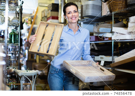 Woman standing with wooden box in decoration and furniture store Woman standing with wooden box in decoration and furniture store 74856478