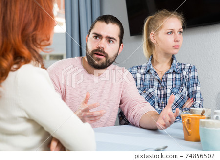 Young serious couple has a family stressful conversation at home Young serious couple has a family stressful conversation at home 74856502