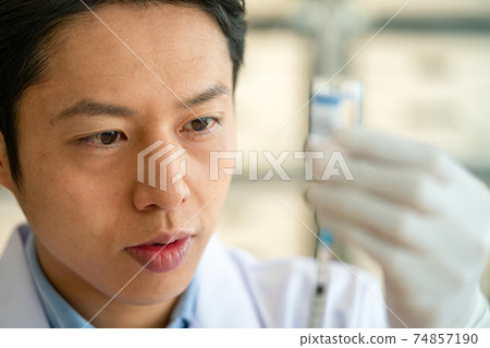 Doctor injecting vaccine 74857190