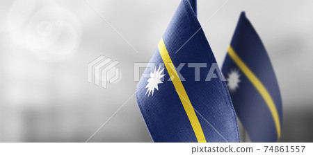 Small national flags of the Nauru on a light blurry background Small national flags of the Nauru on a light blurry background 74861557