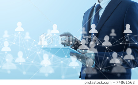 People's connections on the Internet. A man who uses a tablet PC. Network structure and person icons. 74861568