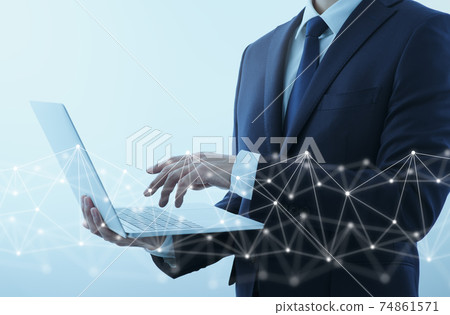 A man in a suit accessing the internet on his laptop. Network structure and gray background. 74861571