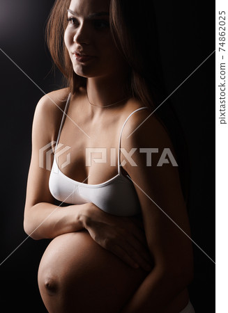Pregnant young woman in underwear in studio Pregnant young woman in underwear in studio 74862025