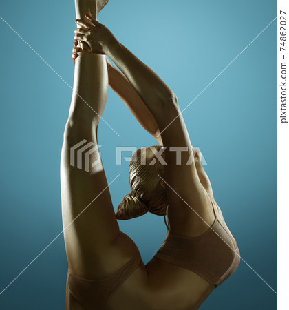 Golden skin woman artistic studio portrait 74862027