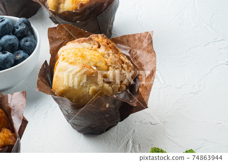 Homemade muffins with fresh blueberries, on white background with copy space for text 74863944
