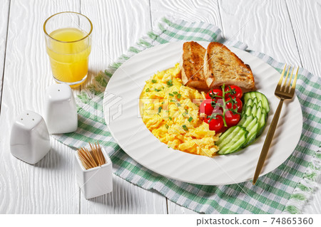 scrambled eggs with veggies and bread on a plate scrambled eggs with veggies and bread on a plate 74865360