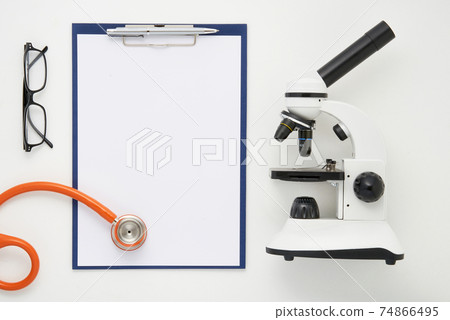 Doctor table with microscope, stethoscope and glasses, top view Doctor table with microscope, stethoscope and glasses, top view 74866495