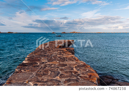 Scenic view of stone pier in the waterfront of Roscoff 74867238