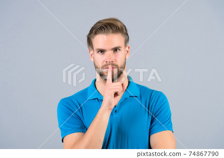 Bearded face with silence finger gesture 74867790