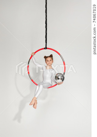 Girl gymnast shows an acrobatic performance 74867819