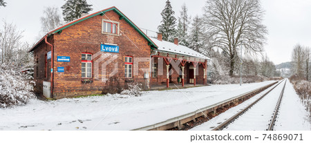 Historic single-track train station covered with fresh snow Historic single-track train station covered with fresh snow 74869071