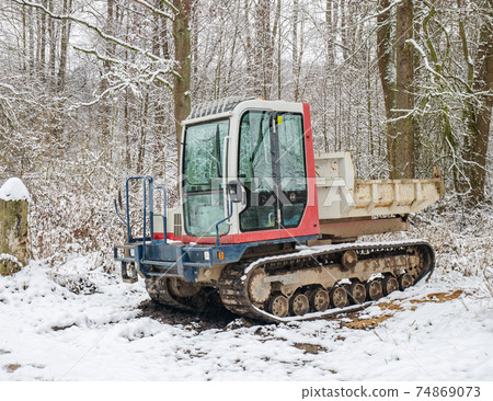 Small Dumper Tracked Truck with Muddy Chassis. The transporter waiting 74869073