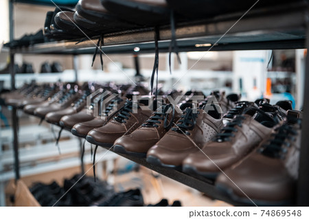 shelf with leather man shoes on modern footwear factory 74869548