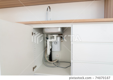 At the bottom of the cupboard of a modern kitchen 74870187