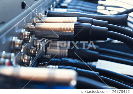 Close up audio jacks cable plugged into mixer console. XLR audio cable Close up audio jacks cable plugged into mixer console. XLR audio cable 74870455