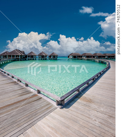 Beautiful beach with water bungalows 74870512