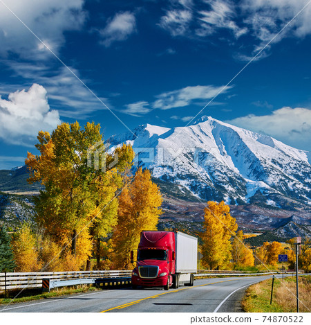 Red truck on highway in Colorado at autumn 74870522