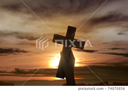 Human hand holding Christian cross 74870856