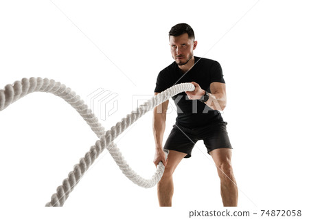 Caucasian professional sportsman training isolated on white studio background. Muscular, sportive man practicing. Caucasian professional sportsman training isolated on white studio background. Muscular, sportive man practicing. 74872058