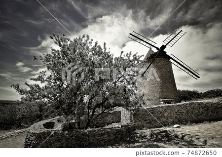 windmill in the countryside, France. miller's habitat for making flour 74872650
